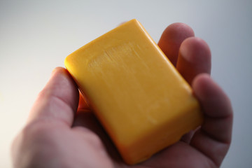 Female hands peeling large yellow ripe mango fruit