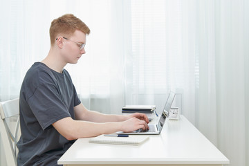 Distance education for students. Quarantine, self-isolation, sociophobia. Young teen listens to online learning