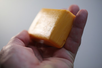 new dry  piece of yellow soap in the hands of a man