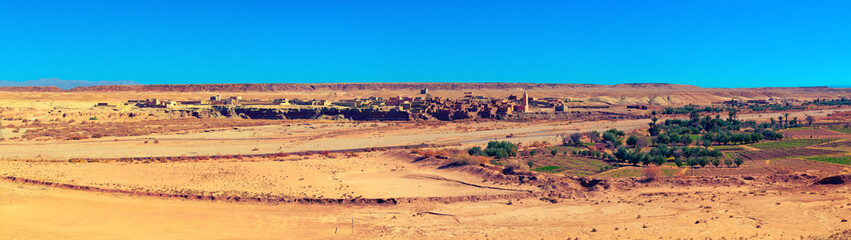 Panoramic view of small Berber settlement in savannah. Douar Itelouane, Ait BenHaddou valley, Morocco