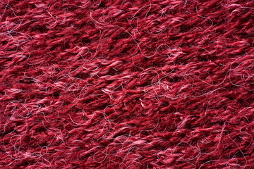 Closeup red texture of woolen knitted fabric. Pattern of red fabric.