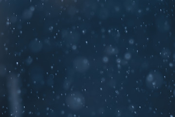 blue snowfall bokeh background, abstract snowflake background on blurred abstract blue