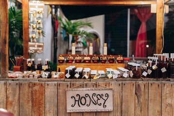 Wooden counter with glass jars of honey