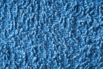 Closeup blue texture of woolen knitted fabric. Pattern of blue fabric.