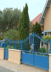 Portail métallique bleu d'une maison	