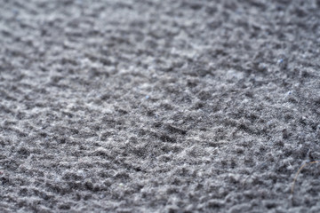 Closeup gray texture of woolen knitted fabric. Pattern of gray crumpled fabric.