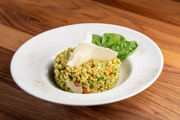 close up of tasty green italian risotto with parmesan