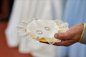 Two Golden Wedding Rings  on a small satin pillows