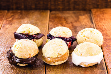 batch of cheese bread, hot, different flavors and fillings. Filling of chocolate, curd, dulce de leche, strawberry jam and guava. Tradition of Minas Gerais gourmet version.