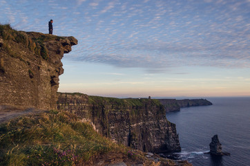 Man standing at the viewpoint Cliffs of Moher
