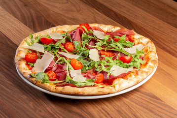 details of tasty italian ham and arugula pizza