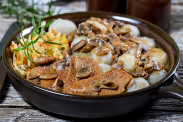 Stewed pork chop in a bright mushroom sauce.