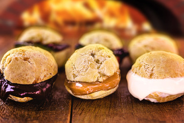 batch of cheese bread, hot, different flavors and fillings. Filling of chocolate, curd, dulce de leche, strawberry jam and guava. Made on the wood stove.