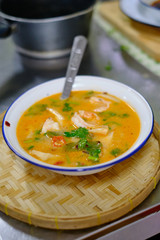 A bowl of freshly prepared Tom Kah soup topped with Cilantro. Concept of Thai food