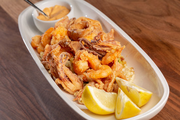 details of tasty fresh fried sea food on wooden table