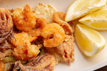 details of tasty fresh fried sea food on wooden table