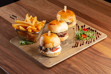 close up of fresh tasty mini burgers and potatoes