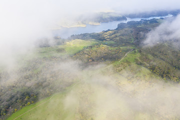 Clouds drift above the bucolic hillside scenery in the East Bay of Northern California. This beautiful region is green in the winter and golden in the summer due to seasonal rainfall patterns.