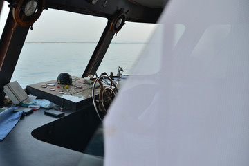 Close view into captain's cabins, navigation equipment. The steering wheel in the ship. Captain's...