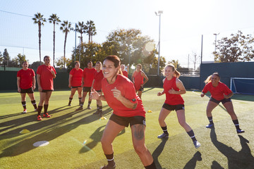 Womens Football Team Training For Soccer Match On Outdoor Astro Turf Pitch