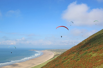 Paragliders flying above Rhossili	