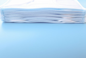 Obraz premium Clean face Masks isolated on light blue blackground against protection infection safe from coronavirus COVID-19 prevention of the spread of virus and pandemic