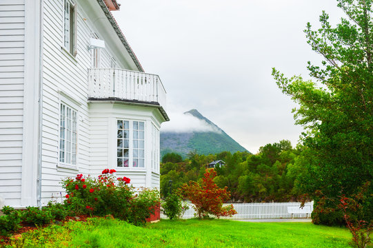 Wooden House With Beautiful Garden In Norway. Summer Landscape