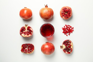 Flat lay with pomegranate, juice and seeds on white background