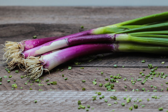 Red Spring Onions On Wooden Background