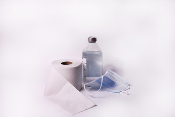 Toilet paper roll, protective mask and saline on white background