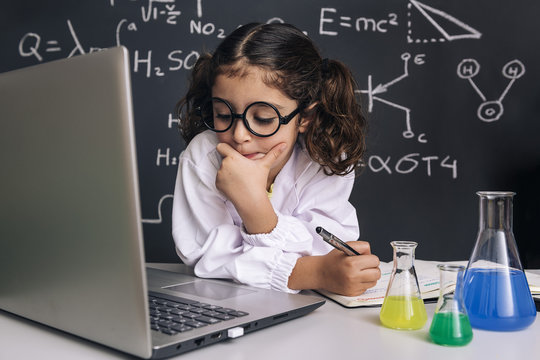 scientist kid looking pensive to the computer