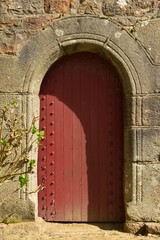 Fototapeta na wymiar Jersey, U.K. 15th century old door in arch.