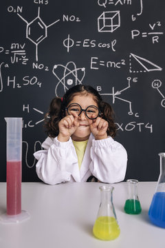 funny child scientist joking with her glasses