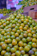 A large pile of limes in a Thai market