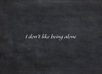 I don't like being alone written on a  blackboard