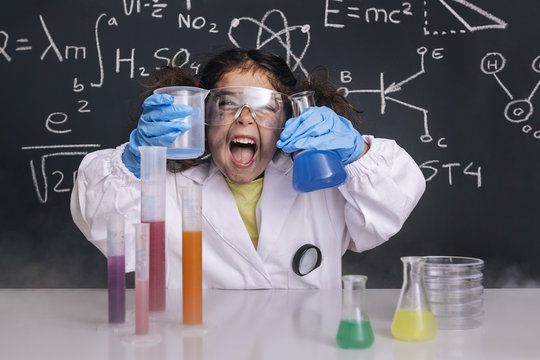 funny scientist girl in lab coat with flasks