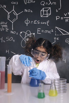 surprised scientist girl mixing chemical flasks