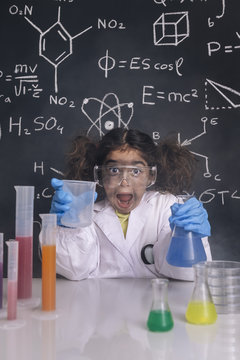 crazy scientist girl with chemical flasks