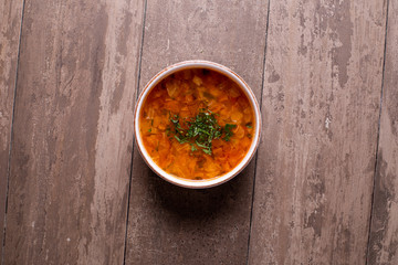 close up of beef veggie soup on wooden table