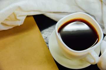 Espresso  in a glass and White cloth ,notebook on black wooden table,Top view