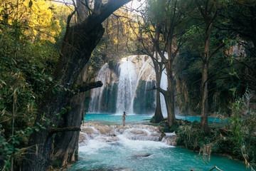 Blue waterfall in the mountains among the jungle