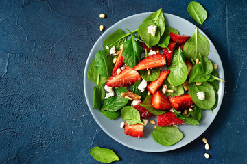 Delicious fresh vegetarian salad with strawberries, spinach and feta