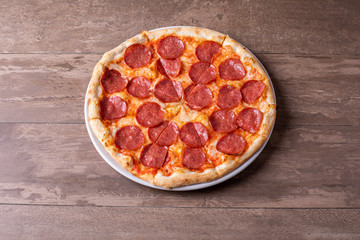 close up of tasty fresh baked salami pizza