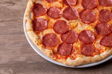 close up of tasty fresh baked salami pizza