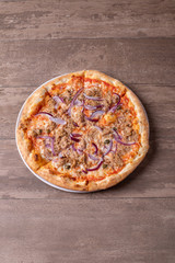 details of tasty tuna pizza with red onions