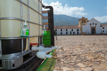 Sink in the main square of Villa de Leyva Boyacá Colombia is used by a man with the aim of preventing viral diseases such as the covid19 coronavirus