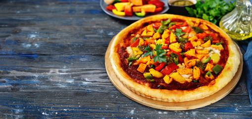 Vegan pizza with vegetables, tomato pesto and cauliflowers creamy cheese
