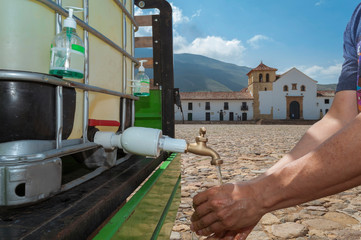 Sink in the main square of Villa de Leyva Boyacá Colombia is used by a man with the aim of...