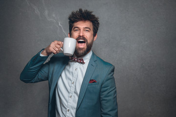Portrait of business man in suit with red bow tie a coffee cup funny face long hair and beard on isolated background