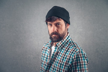 Handsome bearded man in casual clothes with beanie